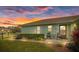 Evening view of house exterior, patio, and landscaping at 8350 High Point Cir # 3, Port Richey, FL 34668