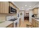 Kitchen boasts wood cabinets, white appliances, and an eat-in area at 8350 High Point Cir # 3, Port Richey, FL 34668