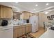 Kitchen with double sink, white appliances, and wood cabinets at 8350 High Point Cir # 3, Port Richey, FL 34668