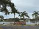 Scenic community lake with gazebo and palm trees at 8350 High Point Cir # 3, Port Richey, FL 34668