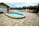 Community pool and spa with lounge chairs at 8350 High Point Cir # 3, Port Richey, FL 34668