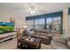 Sunroom with gray leather seating and large windows at 8350 High Point Cir # 3, Port Richey, FL 34668