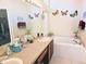 Bathroom with double vanity, garden tub, and butterfly wall art at 9250 Alcott Way, Trinity, FL 34655