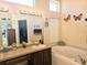 Bathroom with a garden tub and double vanity at 9250 Alcott Way, Trinity, FL 34655