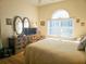 Main bedroom with large bed, dresser, and a window with blinds at 9250 Alcott Way, Trinity, FL 34655