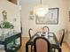 Elegant dining room with chandelier, and a large Asian-themed artwork at 9250 Alcott Way, Trinity, FL 34655