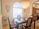 Elegant dining room with a glass-top table and chandelier at 9250 Alcott Way, Trinity, FL 34655