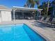 Inviting community pool with covered patio and lounge chairs at 9250 Alcott Way, Trinity, FL 34655