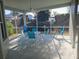 Screened porch with patio furniture and ceiling fan at 9250 Alcott Way, Trinity, FL 34655