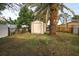 Backyard with storage shed and lush landscaping at 9321 Mansard Ln, Port Richey, FL 34668