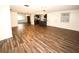 Open concept dining area with hardwood floors and kitchen views at 9321 Mansard Ln, Port Richey, FL 34668