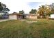 Brick ranch home with a large yard and palm tree at 9321 Mansard Ln, Port Richey, FL 34668