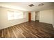 Bright living room with hardwood floors and large windows at 9321 Mansard Ln, Port Richey, FL 34668