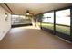 Relaxing screened porch with ceiling fan, overlooking backyard at 9321 Mansard Ln, Port Richey, FL 34668