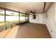 Spacious screened porch with ceiling fan and backyard access at 9321 Mansard Ln, Port Richey, FL 34668