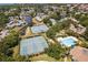 Aerial view showing tennis courts, pool, and community at 1005 Mizzen Ct, Tarpon Springs, FL 34689