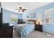 Bright bedroom with ceiling fan and ensuite bathroom at 1005 Mizzen Ct, Tarpon Springs, FL 34689