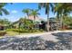 Community clubhouse with lush landscaping and palm trees at 1005 Mizzen Ct, Tarpon Springs, FL 34689