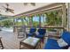 Covered porch with seating overlooking pool at 1005 Mizzen Ct, Tarpon Springs, FL 34689