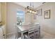 Charming dining room with a rustic table and modern light fixture at 1005 Mizzen Ct, Tarpon Springs, FL 34689
