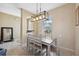 Dining room features a wood table with six chairs and a modern light fixture at 1005 Mizzen Ct, Tarpon Springs, FL 34689