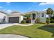 Single-story home with attached garage and landscaped yard at 1005 Mizzen Ct, Tarpon Springs, FL 34689