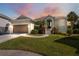 Single-story home with attached garage and landscaped yard at 1005 Mizzen Ct, Tarpon Springs, FL 34689