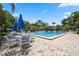 Inviting community pool with blue umbrellas and seating at 1005 Mizzen Ct, Tarpon Springs, FL 34689