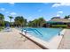 Community pool with lounge chairs and brick patio at 1005 Mizzen Ct, Tarpon Springs, FL 34689