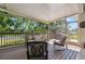 Spacious screened porch with comfortable seating and a grill at 1005 Mizzen Ct, Tarpon Springs, FL 34689