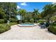 Community spa with seating and lush landscaping at 1005 Mizzen Ct, Tarpon Springs, FL 34689