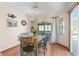 Cozy dining area with a wooden table and four chairs, near sliding doors at 10239 Hoover St, Spring Hill, FL 34608