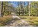 Long driveway leading to a house nestled in the woods at 10417 Joyce Dr, Brooksville, FL 34601