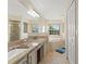 Double vanity bathroom with granite countertop and jacuzzi tub at 10451 Keystone St, Spring Hill, FL 34608