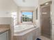 Bathroom with corner jacuzzi tub, shower, and granite vanity at 10451 Keystone St, Spring Hill, FL 34608