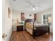 Bedroom with wood flooring, plantation shutters and ceiling fan at 10451 Keystone St, Spring Hill, FL 34608