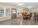 Dining room with hardwood floors, plantation shutters and large mirror at 10451 Keystone St, Spring Hill, FL 34608