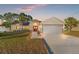 House exterior featuring a two-car garage and well-manicured lawn at 10451 Keystone St, Spring Hill, FL 34608