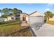 Front view of a single-story house with a two car garage at 10451 Keystone St, Spring Hill, FL 34608