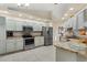 Modern kitchen with stainless steel appliances and light cabinets at 10451 Keystone St, Spring Hill, FL 34608
