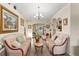 Living room with light beige sofas and a beautiful chandelier at 10451 Keystone St, Spring Hill, FL 34608