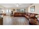 Open living area with a large sectional sofa and wood-look floors at 10451 Keystone St, Spring Hill, FL 34608