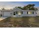 Single story home with front yard and driveway at 10841 Gawain Rd, Port Richey, FL 34668