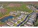 Aerial view of a residential neighborhood with houses and trees at 11243 Merganser Way, New Port Richey, FL 34654