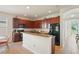 Kitchen with an island, dark wood cabinets, and a breakfast nook at 11243 Merganser Way, New Port Richey, FL 34654