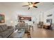 Spacious living room with tiled floors and access to a screened patio at 11243 Merganser Way, New Port Richey, FL 34654