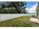 Grass backyard with a white privacy fence at 11922 Bristol Bridge Rd, Spring Hill, FL 34610