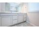 Double vanity bathroom with light gray cabinets and tiled floor at 11922 Bristol Bridge Rd, Spring Hill, FL 34610