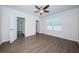 Bright bedroom with wood-look floors and access to bathroom and hallway at 11922 Bristol Bridge Rd, Spring Hill, FL 34610