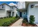 Welcoming front entry with a dark blue door and walkway at 11922 Bristol Bridge Rd, Spring Hill, FL 34610